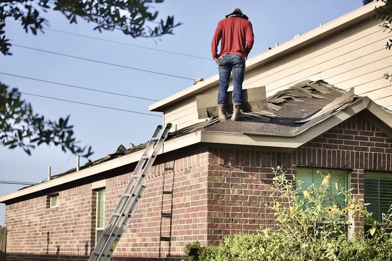 Professional roofer working on a residential roof in Del Mar